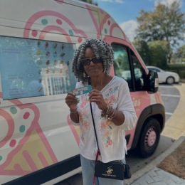 a woman standing near an ice cream truck