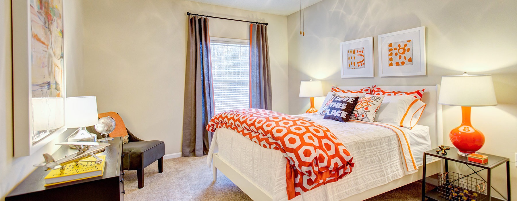 Large well lit bedroom with carpets and a large window