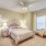 Large well lit bedroom with plush carpets and large windows 
