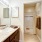 Large well lit bathroom with white accents 