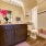 Large well lit bathroom with white accents 