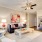 Spacious and well lit living room with wood flooring, large windows and open access to the kitchen